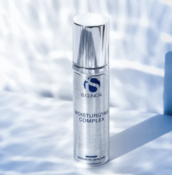 A silver bottle of Moisturising Complex 50g stands upright on a light surface with water ripples in the background, displaying the "Innovative Skincare" label.